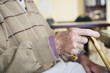 An elderly man holding a walking stick