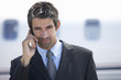 A businessman standing by a plane