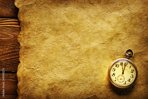 Photo: Pocket clock on old paper Pocket clock on old paper
