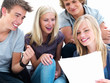 Young students sitting on floor holding white page