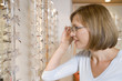 Woman trying on eyeglasses at optometrists