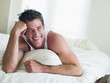 Man lying in bed smiling