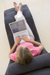 Woman sitting in chair using laptop