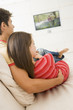 Couple in living room watching television