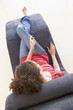 Woman sitting in chair listening to MP3 player