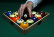 A woman places Balls on a pool (billard) table before play