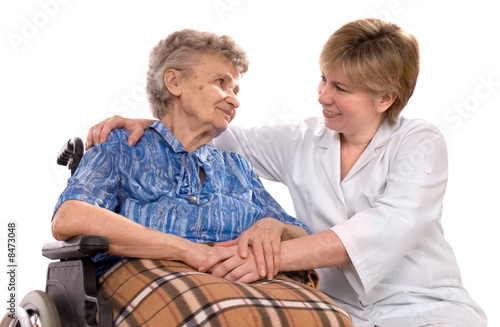 Photo: Health care worker and elderly woman in wheelchair needs help Health care worker and elderly woman in wheelchair needs help