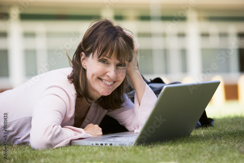 Photo: Woman using laptop on campus Woman using laptop on campus