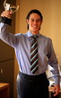 Young businessman holding trophy