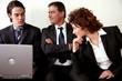 Three people sitting in a waiting room