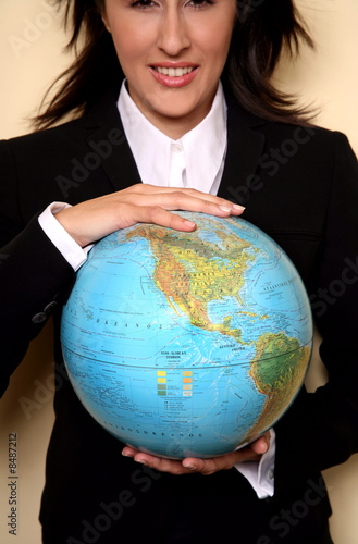 Photo: A woman holding a globe A woman holding a globe