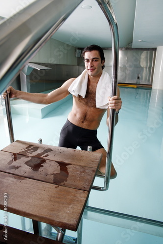 Photo: Young man in a swimming pool at a spa Young man in a swimming pool at a spa