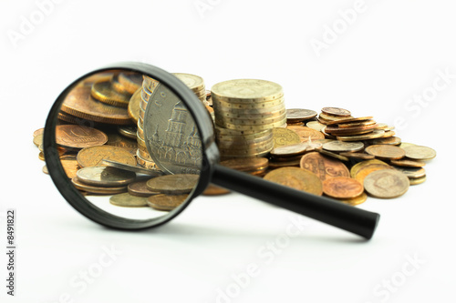 Coins and magnifying glass Coins and magnifying glass