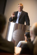 Photo: Businessman giving presentation at podium Businessman giving presentation at podium
