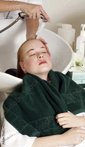 Photo: Young woman having her hair washed at a salon Young woman having her hair washed at a salon