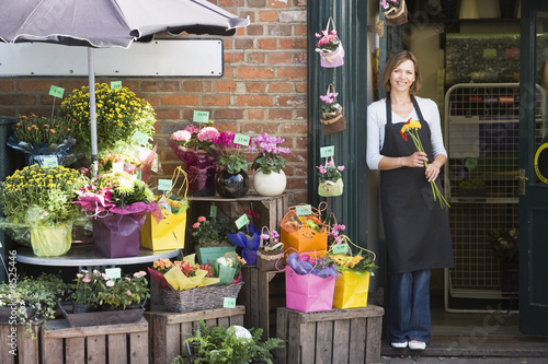 Photo: Woman working at flower shop smiling Woman working at flower shop smiling