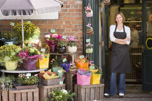Photo: Woman working at flower shop smiling Woman working at flower shop smiling