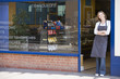 Photo: Woman standing in doorway of restaurant smiling Woman standing in doorway of restaurant smiling