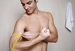 Man measuring his arm muscle