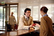 Man checking in at the hotel reception desk