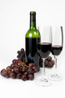 Bottle and two glasses of red wine on white background