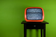 Red old retro television on green room