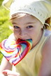 Young girl licking a lollipop