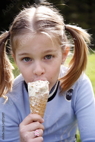 Photo: Young girl eating ice cream Young girl eating ice cream