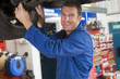 Photo: Mechanic working under car smiling Mechanic working under car smiling