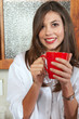 Sexy brunette eating breakfast