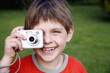 Little boy holding a camera