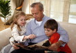 Grandfather relaxing with grandchildren
