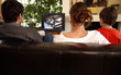 Couple watching television with young boy