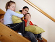 Mother with tired children on staircase