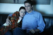 Young couple watching television