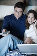 Young couple watching television