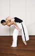 Partners practicing flexibility in yoga and Capoeira programs