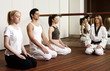 Participants in a fitness class meditating