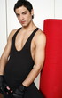 Young man leaning on punching bag