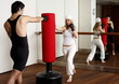 Young man and woman hitting the punching bag