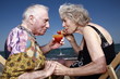 Senior couple with cocktail on beach