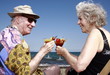 Photo: Senior couple with cocktails on beach Senior couple with cocktails on beach