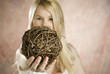 blond holding tree branch ball
