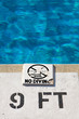 "no diving" sign on a pool deck