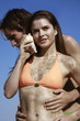 Photo: Female young adult with seashell and male young adult Female young adult with seashell and male young adult