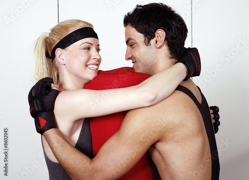 Photo: Young man and woman flirting in a fitness class Young man and woman flirting in a fitness class