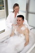 Mature couple having fun in the bathtub