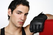 Young man leaning on punching bag