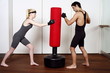 Young man and woman practicing with a punching bag