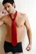 Bare chested young man posing with shorts and tie
